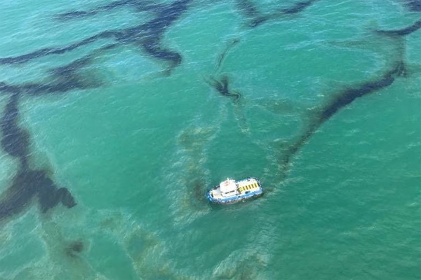 Un barco navega durante un vertido de petróleo en la playa de Las Palmas, en Balao, Ecuador, en esta imagen publicada el 19 de julio de 2023.  