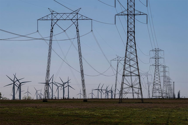 Wind turbines and power transmission lines in Rio Vista, Calif., March 30, 2021.
