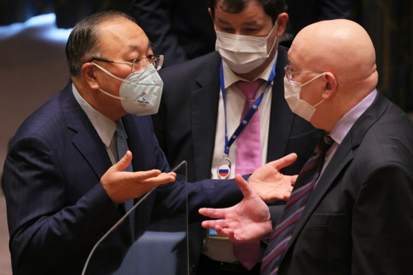 Zhang Jun, Chinese ambassador to the United Nations, and Vasily Nebenzya, Russian ambassador to the United Nations, speak before the start of a meeting to discuss the crisis in Ukraine at the United Nations headquarters in New York on March 7.