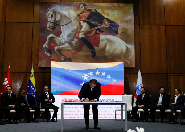 Chevron's President for Venezuela Javier La Rosa signs a deal to expanding operations in the country, in Caracas, Venezuela, December 2, 2022