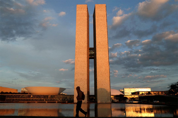 A man walks near the National Congress building, amid the coronavirus disease (COVID-19) outbreak, in Brasilia, Brazil, March 19, 2021. 