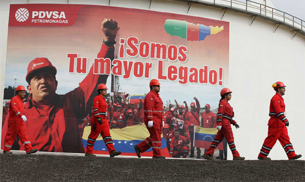 Venezuela's PDVSA workers in fron of Chavez in a billboard 