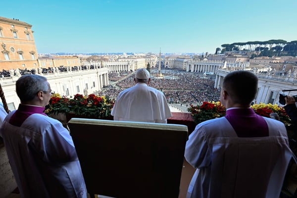 This handout picture taken and released on December 25, 2022 by Vatican Media, shows Pope Francis delivering his Christmas 'Urbi et Orbi' - "to the city and the world" blessing, as he stands on the balcony overlooking St. Peter's Square at The Vatican. (AFP)