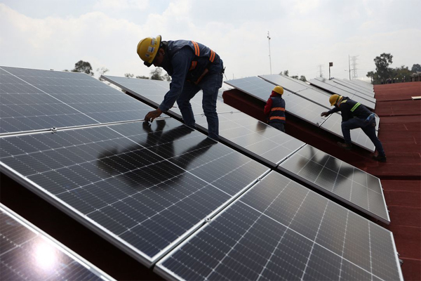 Workers install solar panels on the roof of the Central de Abastos wholesale market  in Mexico City, Mexico July 27,2022.