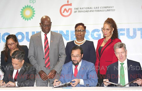 Prime Minister Dr Keith Rowley and government officials witness the signing of the heads of agreement of Atlantic LNG shareholders, from left, Shell TT country chairman Eugene Okpere, NGC president Mark Loquan, Energy Minister Stuart Young and bpTT president David Campbell at Hilton Trinidad, Port of Spain on Tuesday. 
