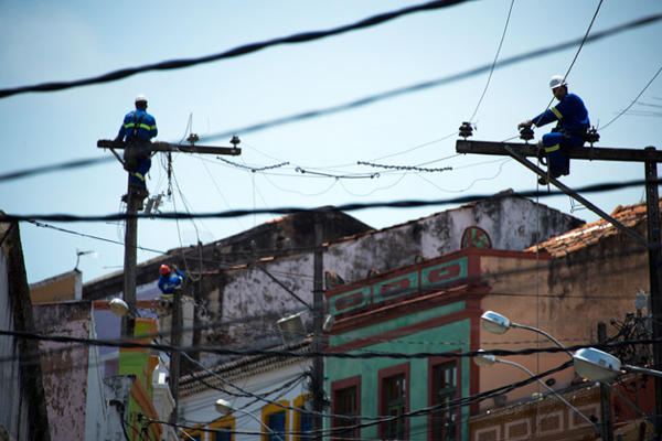 Workers repair an electricity line in Olinda, Brazil 