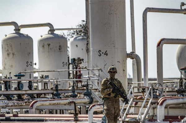 A US soldier looks on while on patrol by the Suwaydiyah oil fields in Syria's northeastern Hasakah province on 13 February, 2021 (AFP/File photo)