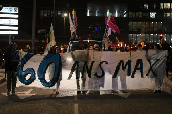 Protesters hold a banner reading '60 years max', during a march in Toulouse on Feb. 2.