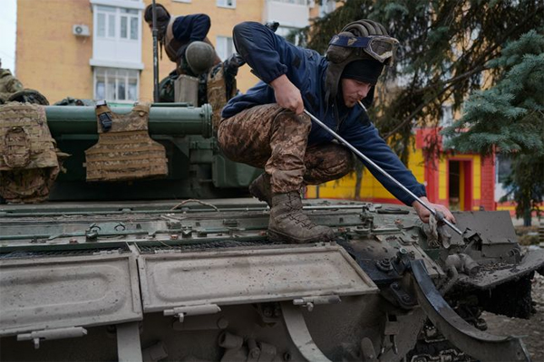 A Ukrainian soldier of the 24th brigade controls the oil level of a tank on December 24, 2022 in Bakhmut, Ukraine.