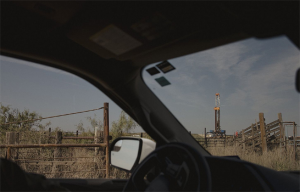 A Chevron representative drives to a drill rig site in Culberson County, Texas. 