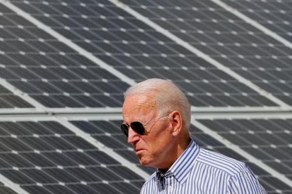 Joe Biden walks past solar panels while touring the Plymouth Area Renewable Energy Initiative in Plymouth, New Hampshire, U.S., June 4, 2019.  
