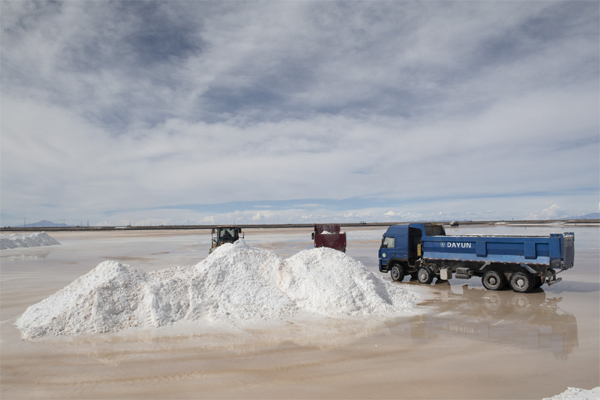 Workers load salt deposits onto trucks inside a state-owned lithium production facility in Potosi, Bolivia. 