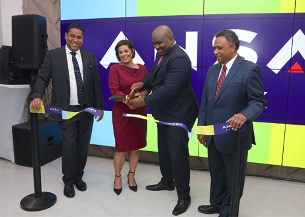 Minister in the Ministry of Finance Brian Manning, second from right, and Kathleen Galy, managing director of ANSA Bank cut the ribbon to officially open ANSA Bank Digital Touchpoint at Gulf City Mall, La Romain, yesterday. Looking on, from left, are Gregory N Hill, director and managing director of Ansa Merchant Bank and David j Dulal-Whiteway, chairman.