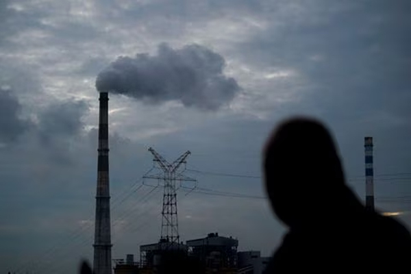 A man walks past a coal-fired power plant in Shanghai, China, October 14, 2021. 