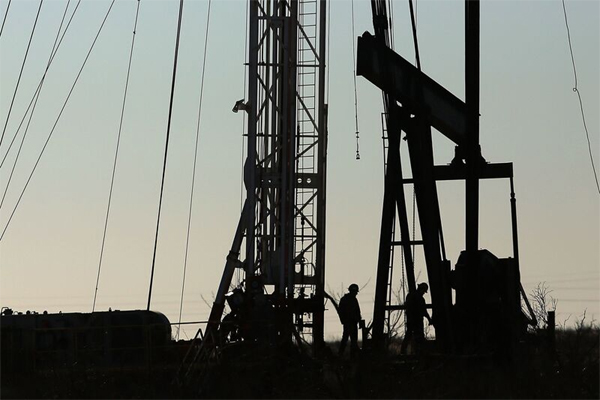 Workers at a Permian Basin drilling site in the oil town of Andrews, Texas.