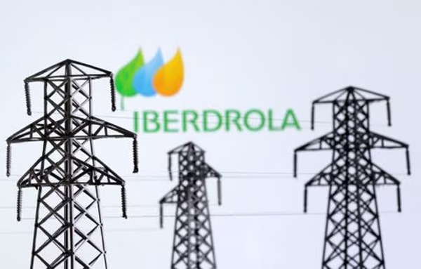 Electric power transmission pylon miniatures and Iberdrola logo are seen in this illustration taken, December 9, 2022. 