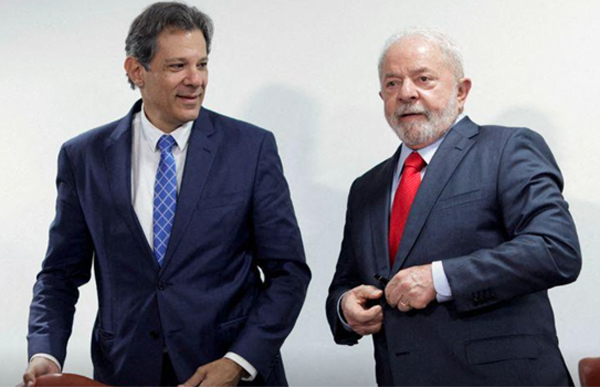 Brazil's Economy Minister Fernando Haddad greets President Luiz Inacio Lula da Silva during a meeting to sign the government's economic package at the Planalto Palace in Brasilia, Brazil January 12, 2023.  