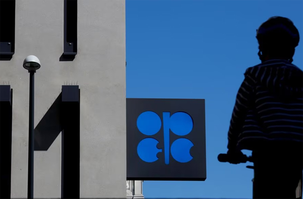 A person passes the logo of the Organization of the Petroleoum Exporting Countries (OPEC) in front of OPEC's headquarters in Vienna, Austria April 9, 2020.  