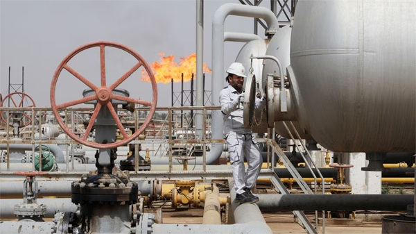 A worker checks a tank at Nahr Bin Umar oil field, north of Basra, Iraq March 22, 2022. REUTERS/Essam Al-Sudani