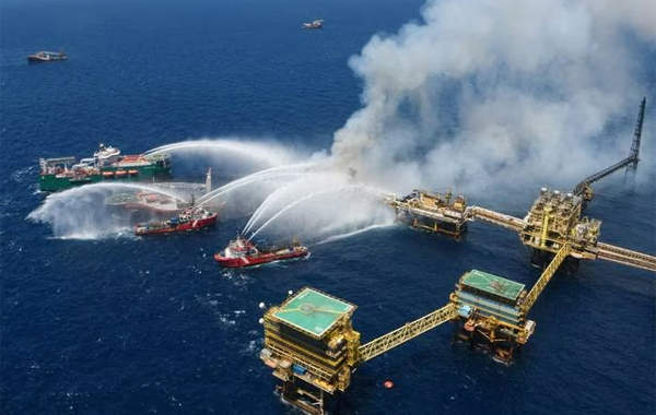 Boats spray water on to the offshore oil platform that caught fire at the Pemex's Cantarell Field in the Bay of Campeche, Gulf of Mexico. Photo: Pemex