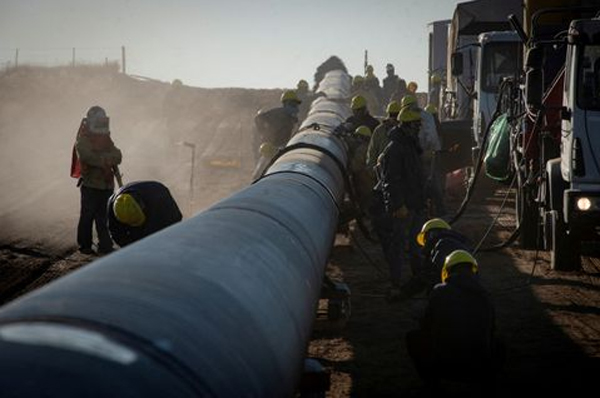 Workers are pictured during the construction of the Nestor Kirchner gas pipeline, which first stage was inaugurated on Sunday to transport natural gas from the Vaca Muerta formation in western Argentina to the province of Santa Fe, passing through the province of Buenos Aires, in Macachin, La Pampa, Argentina April 26, 2023.  