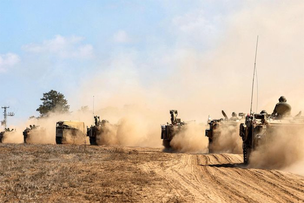  Israeli army tanks and vehicles deploy along the border with the Gaza Strip in southern Israel on October 13, 2023. Oil prices climbed on fears of an escalating war declared by Israeli on Hamas after its deadly surprise attack of nearly a week ago. Jack Quez/Agence France-Presse/Getty Images 