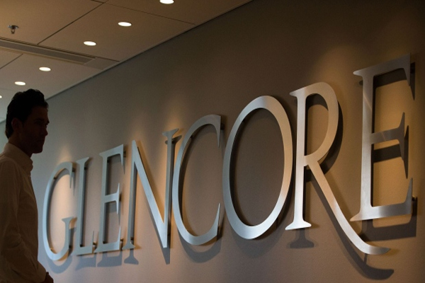 An employee stands by a logo for Glencore Agriculture in Glencore Plc's offices in Rotterdam, Netherlands, on Tuesday, April 25, 2017. Since taking over Glencore Agriculture in 2002, Chris Mahoney has overseen the transformation of the unit into a standalone enterprise that generates more revenue from owning fixed assets in strategic locations than simply trading. Photographer: Simon Dawson/Bloomberg , Bloomberg