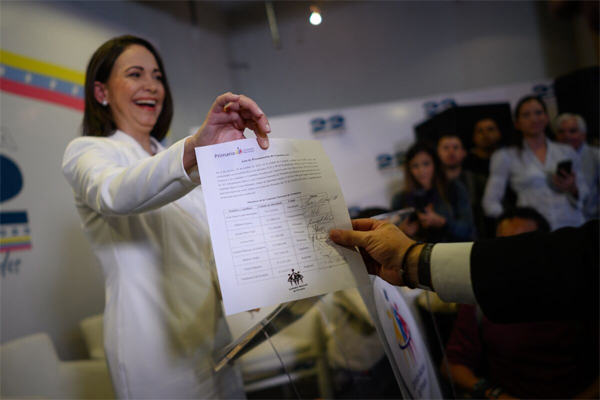 María Corina Machado displays a document proclaiming her victory in Venezuela’s opposition primaries during a ceremony in Caracas on Oct. 26.Photographer: Gaby Oraa/Bloomberg
