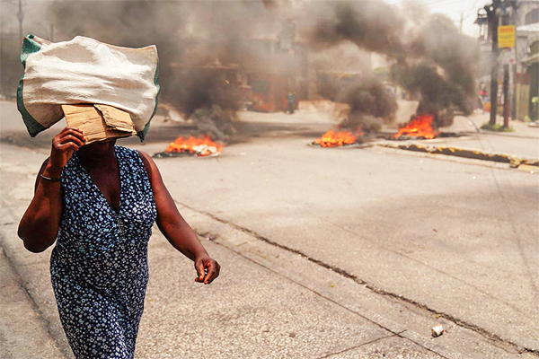 Tires burn on a street in Port-au-Prince, Haiti, in 2022 amid shortages of food and fuel. Gang violence has increased after a crisis fueled by the 2021 assassination of President Jovenel Moïse.
(AFP/Getty Images/Richard Pierrin)