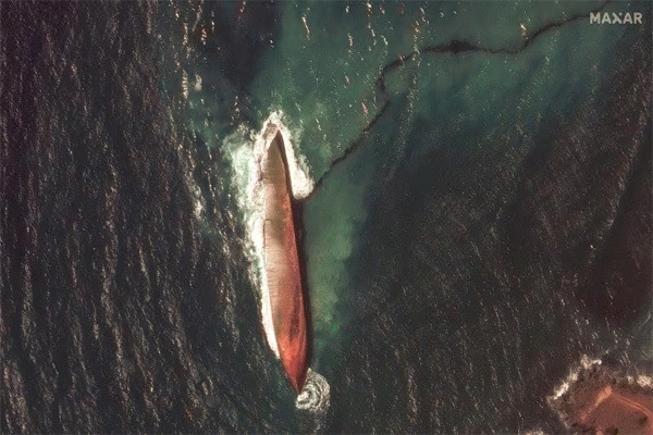 A satellite image shows a close-up view of a capsized barge and an oil spill, off the shore of Tobago Island, Trinidad and Tobago, February 14, 2024. Maxar Technologies/Handout 