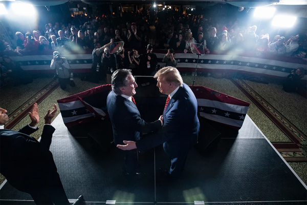 Former president Donald Trump shakes hands with North Dakota Gov. Doug Burgum (R), who is leading the Trump campaign’s development of its energy policy, at a rally in Laconia, N.H., on Jan. 22. (Jabin Botsford/The Washington Post)