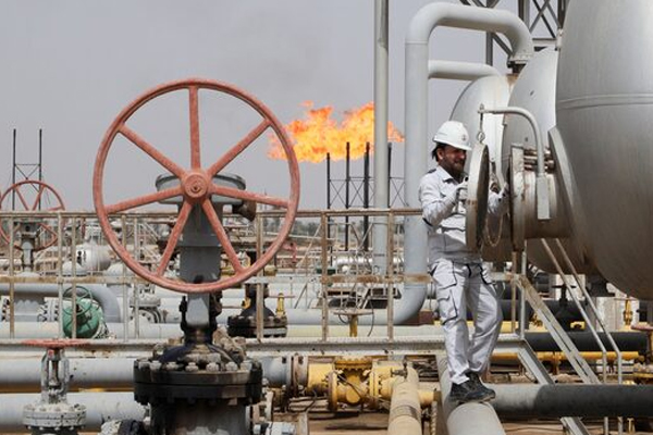 A worker checks a tank at Nahr Bin Umar oil field, north of Basra, Iraq March 22, 2022. REUTERS/Essam Al-Sudani