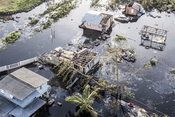 Destroyed homes and vehicles sit in floodwaters after Hurricane Maria hit Puerto Rico in 2017. Alex Wroblewski/Bloomberg