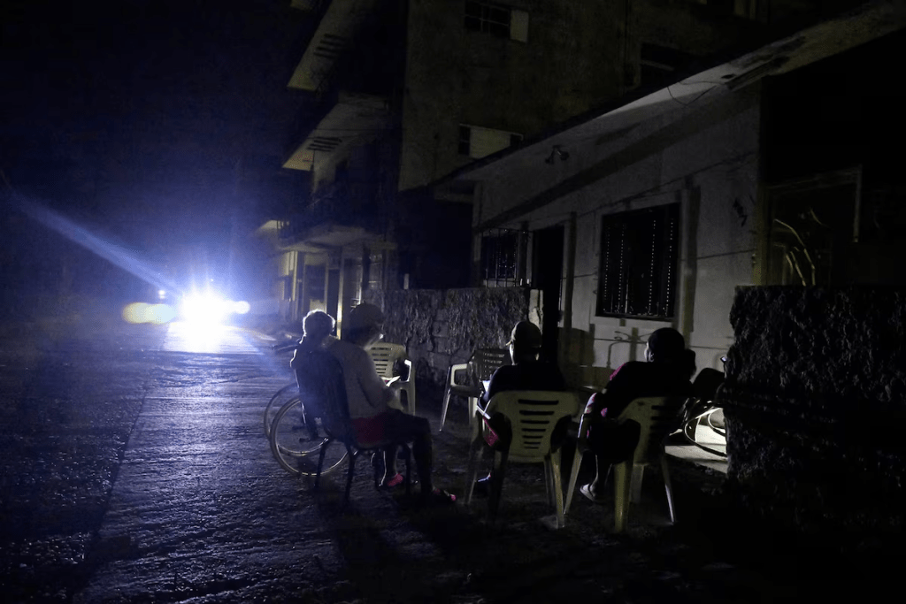 People sit outside their home during a blackout following the failure of a major power plant, Havana, Cuba February 13, 2025. REUTERS/Norlys Perez